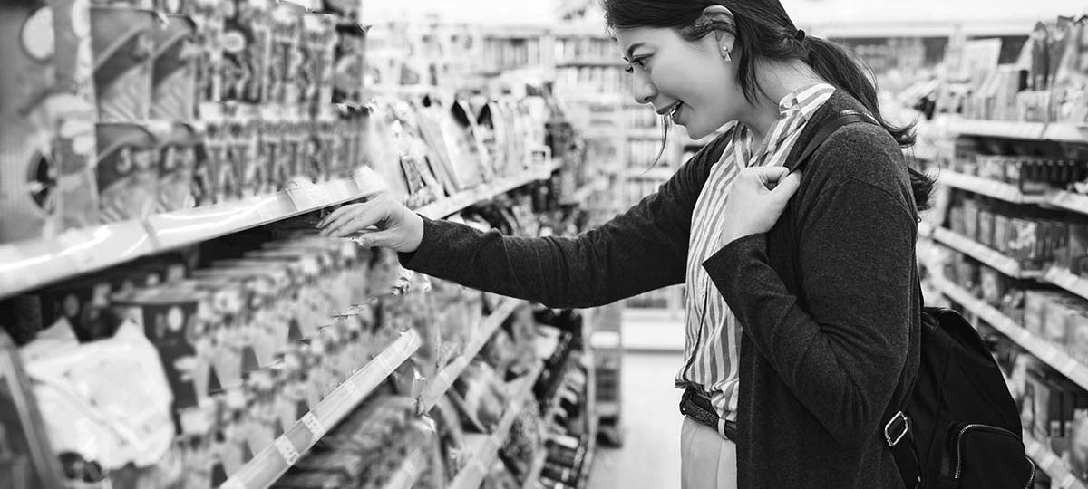 a woman looking at products in a convenience store