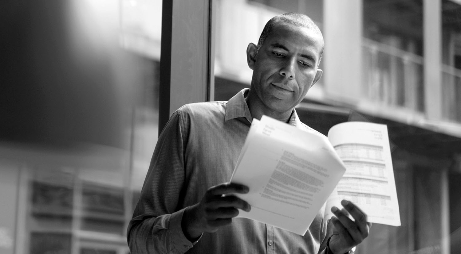 man looking at paperworks